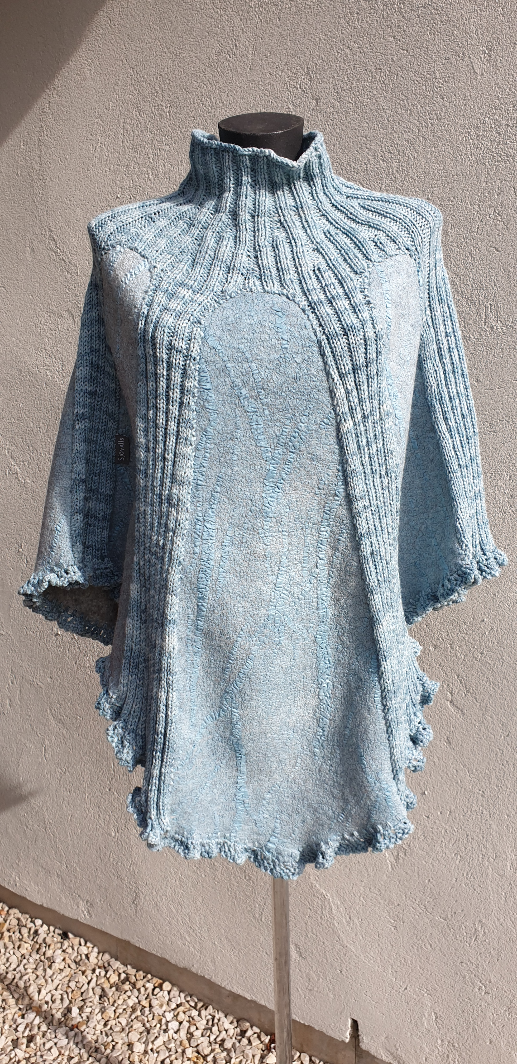 Ljusblå poncho